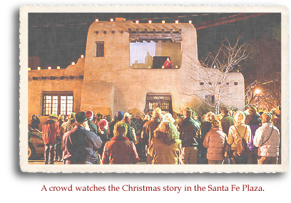 A crowd watches the Christmas story in the Santa Fe Plaza.