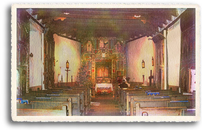 The interior of el Santuario de Chimayo is a rustic chapel which is dwarfed by its magnificent carved altar.