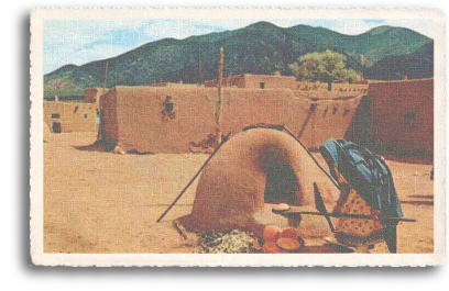 A Native American woman prepares food in a horno (adobe oven), with Taos Mountain and the some of the dwellings of the historic Taos Pueblo visible behind her. Even today, tourists can enjoy fresh-baked fry bread during their visit to the 1,000-year-old Taos Pueblo, just north of the town of Taos, New Mexico.
