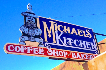 Michael's Kitchen sign over the historic adobe building in the center of Taos has been an icon since the 1970s. Locals and tourists alike gather here for the best breakfast in Taos, fantastic Mexican fare, and fresh baked pastries.