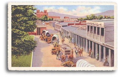 This vintage postcard features the old covered-wagon days in downtown Santa Fe, New Mexico. In the distance you can see the St. Francis Cathedral and the original La Fonda Hotel.